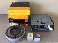 Wide shot showing slide trays, projector, and bulbs