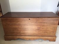 Front view of Lane cedar chest showing medium brown finish and decorative base edge.