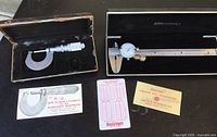 Overview of both Starrett micrometer and Modern Tools dial caliper with their cases and instruction cards