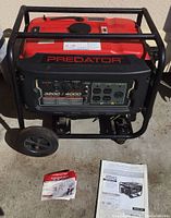 Front view showing control panel, outlets, branding and manual on ground