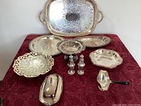 Full view of the entire set on red cloth showing trays, dishes, butter dish, handled pourer, salt and pepper shakers, and compote bowl.