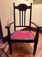 Front view of mahogany Edwardian armchair with red leather seat