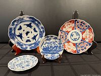 Group view of four plates on stands