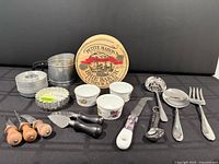 Entire lot displayed including brie baker, ramekins, tart pans, sifter, cheese tools and serving utensils