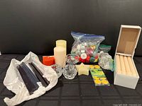 Entire assortment laid out including tapers, pillars, floating candles, tealights, holders