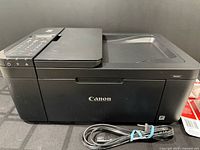 Front view of Canon PIXMA TR4527 printer with power cord