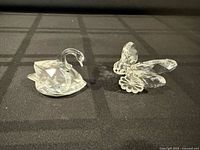 Swan and butterfly crystal figurines side by side