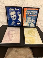 Group shot of all four framed sheet music pieces
