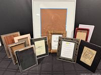 Group shot of all eleven frames including large 16x20 matted frame and ten assorted small frames