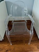 Front view of clear acrylic Ghost-style armchair