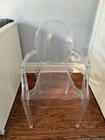 Front view of clear acrylic ghost-style armchair