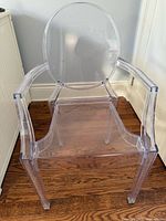 Front view of clear acrylic ghost-style chair showing full structure