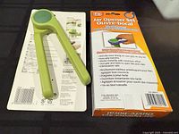 packaged green garlic press and jar opener box