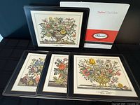 Four placemats displayed with box showing branding and artwork