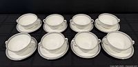 Full set of eight bowls on saucers displayed