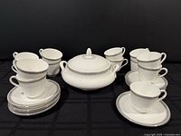 Group view of vegetable dish with lid, cups and saucers