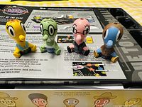 Four Cranium character figurines placed on game board surface