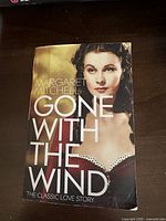 Front cover of the paperback book 'Gone with the Wind' showing the title, author name, and a woman in a vintage dress.