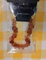 Bracelet in retail packaging with Gemoria branding and visible natural stone chips.