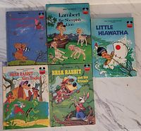 Front covers of the 5 Disney hardcover books arranged on a marble surface showing colorful illustrations for Winnie the Pooh, Lambert the Sheepish Lion, Little Hiawatha, and two Brer Rabbit titles.