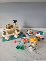 Full playset including base station, 5 space vehicles, 6 human astronauts, and one alien figure arranged on marble surface.
