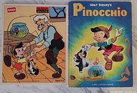 Photo of the vintage Playskool Pinocchio wooden board puzzle alongside the Walt Disney Pinocchio hardcover storybook showing front covers.