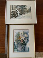 Two original watercolour paintings by Karl Rieche laid flat on a table with ruler for scale, one depicting a snowy landscape and the other a flower bouquet.