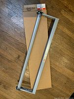 Uline 30 inch paper cutter frame on top of cardboard box.