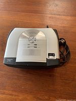 Top view of Viewsonic PJ402D projector showing control buttons and power cable.