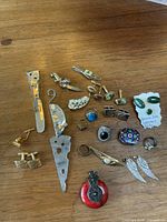 Photo showing full selection of vintage brooches, cufflinks, rings, pendants including jade set and enamel brooch