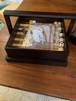 Vintage Restoration Hardware dark wood game box with glass top showing assorted dice and game pieces inside