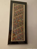 Full view of the vertically oriented framed painting showing colorful diagonal rows of stylized birds and geometric patterns.