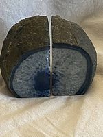 Front view of blue agate geode bookends showing polished interiors and rough exteriors.