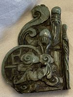 Front angled view of vintage green jade carved figurine depicting elderly man with walking stick and ornate design base.