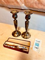 Pair of silver candlesticks with fork and cutter set in original box on table