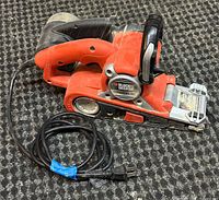 Overall view of the BLACK+DECKER Dragster belt sander with power cord.