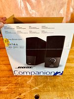 Front of original BOSE Companion 2 speaker box showing image of speakers and product branding.