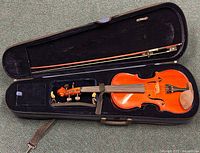 Violin and bow inside black rectangular case