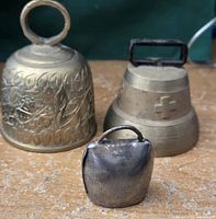 Photo of all three metal bells showing size and design differences