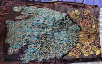 Full view of brown scarf with detailed embroidered peacock design and floral accents