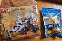 Photo of LEGO Technic NASA Mars Rover Perseverance building set new in sealed bag and LEGO Pokemon Pikachu figure set in sealed bag.