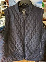 Front view of the dark navy blue Northern Reflections women's quilted vest with full front zipper and zippered side pockets.