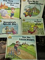 Five vintage children's books laid out showing their colorful front covers with illustrated characters and titles.