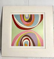 Front view of matted abstract art print showing rounded organic shapes in various colors and visible signature and title on matte border.