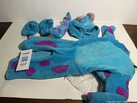Full set of infant plush Sulley costume laid flat showing hood, sleeves, and booties.