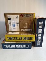 Four boxed Mark Rober Crunch Labs engineering kits stacked, boxes labeled 'Think Like an Engineer' and 'Crunch Labs by Mark Rober'