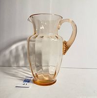 Full view of the pink depression glass pitcher showing shape, size and bevelled pattern.