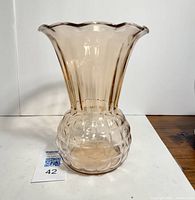 Front view of the pink fluted glass vase showing the flared scalloped rim and quilted pineapple pattern base.