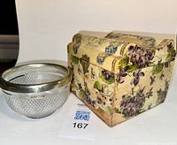Photo showing Victorian vanity box with floral celluloid cover next to cut glass bowl with silverplate rim.