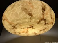 Close-up view of the Art Deco marbleized glass pendant light shade showing tan, rust, and burgundy brown swirling pattern.